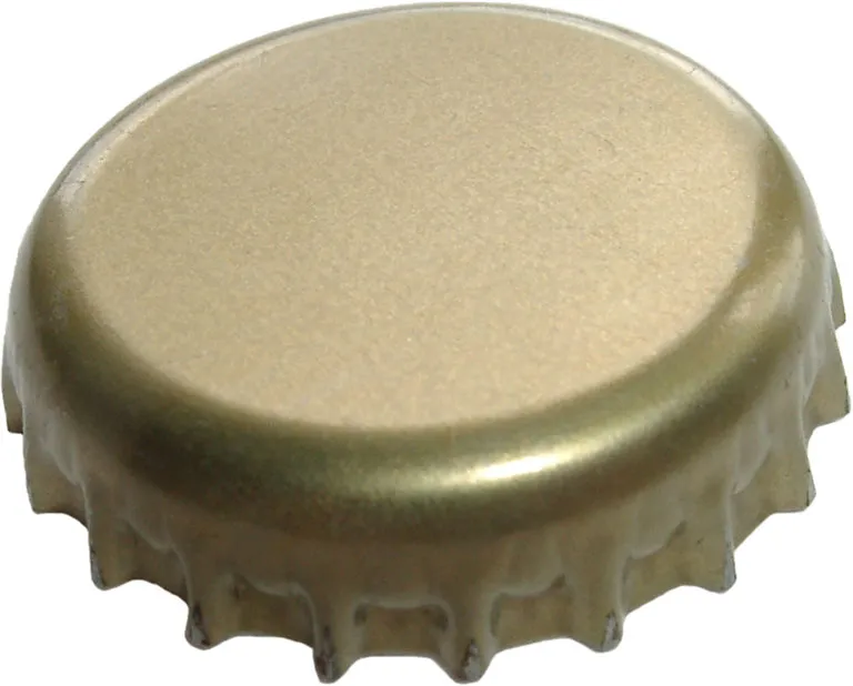 Close-up of a single gold metal crown cap showing its crimped, fluted edge